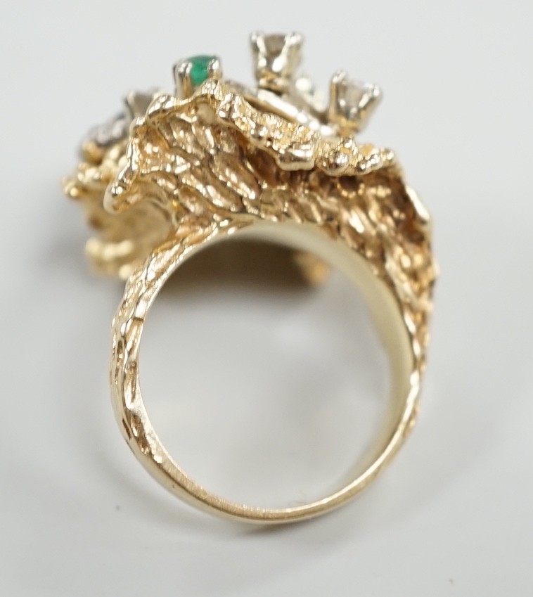 A modern 14k, emerald and diamond cluster set modernist dress ring, size L, gross weight 13.4 grams.